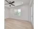 Spacious bedroom with hardwood floors, large window, and access to balcony at 6012 Kipps Colony E Dr, Gulfport, FL 33707