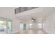 Bright living room with high ceilings, hardwood floors, and access to a balcony at 6012 Kipps Colony E Dr, Gulfport, FL 33707