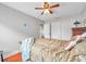 Well-lit bedroom featuring wood floors, ceiling fan, and a double closet at 5176 Salmon Se Dr # A, St Petersburg, FL 33705