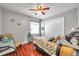 Secondary bedroom with wood floors, ceiling fan, and a closet at 5176 Salmon Se Dr # A, St Petersburg, FL 33705
