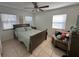 Bedroom features a bed and a chair with multiple throw pillows at 15536 Bristol E Cir, Clearwater, FL 33764