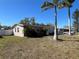 Charming single-story home with mature landscaping and a well-manicured lawn on a sunny day at 15536 Bristol E Cir, Clearwater, FL 33764