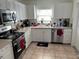 Efficient kitchen with stainless steel appliances, tile backsplash, and ample cabinet space at 15536 Bristol E Cir, Clearwater, FL 33764