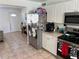 Bright kitchen featuring white cabinetry, stainless steel appliances, and tile flooring at 15536 Bristol E Cir, Clearwater, FL 33764