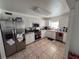 Bright kitchen featuring white cabinetry, stainless steel appliances, and tile flooring at 15536 Bristol E Cir, Clearwater, FL 33764