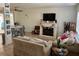 Cozy living room with fireplace, neutral tones, and tile flooring, perfect for relaxation and entertainment at 15536 Bristol E Cir, Clearwater, FL 33764