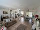 Bright, open living space with tile flooring, a cozy sofa, and easy access to the kitchen and dining area at 15536 Bristol E Cir, Clearwater, FL 33764