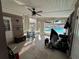 Enclosed patio with a ceiling fan provides access and views of the sparkling pool at 15536 Bristol E Cir, Clearwater, FL 33764