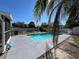 Beautiful pool with a concrete deck, partially shaded by a palm tree, perfect for enjoying sunny days at 15536 Bristol E Cir, Clearwater, FL 33764