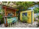 Relaxing backyard with painted bar, shed, and lush landscaping at 1627 Dander Dr, Holiday, FL 34690