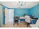 Bright home office features a white desk, teal walls, and chandelier at 1627 Dander Dr, Holiday, FL 34690