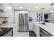 Modern kitchen with stainless steel appliances and white cabinets at 1627 Dander Dr, Holiday, FL 34690