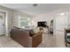 Bright living room with a neutral color palette, tiled floors, and comfortable leather sofa at 7226 Onyx N Dr, St Petersburg, FL 33702