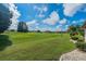 View of backyard with golf course in the background at 739 Winterbrooke Way, Sun City Center, FL 33573