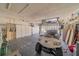 Garage with golf cart, storage cabinets, and flooring at 739 Winterbrooke Way, Sun City Center, FL 33573