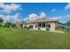 Back exterior view of house and surrounding landscape at 739 Winterbrooke Way, Sun City Center, FL 33573