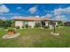 Back exterior of house with landscaping and a screened enclosure at 739 Winterbrooke Way, Sun City Center, FL 33573