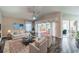 Spacious living room with tile floors, fireplace, and sliding glass doors to patio at 739 Winterbrooke Way, Sun City Center, FL 33573