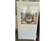 White refrigerator with a patriotic wreath decoration at 739 Winterbrooke Way, Sun City Center, FL 33573