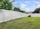 Backyard with white fence and grassy area at 10708 Bamboo Rod Cir, Riverview, FL 33569