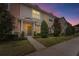 Evening view of charming townhouses with landscaped yards at 1139 Sleepy Oak Dr, Wesley Chapel, FL 33543