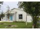 Newly built home with a small front yard and blue door at 4004 E Osborne Ave, Tampa, FL 33610