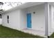 Small back patio with light blue door and porch light at 4004 E Osborne Ave, Tampa, FL 33610