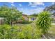 Attractive Florida home with lush landscaping and a vibrant yellow exterior at 1627 Dander Dr, Holiday, FL 34690