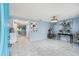 Bright living room with light blue walls and white tile floors at 1627 Dander Dr, Holiday, FL 34690