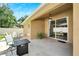 Covered patio with seating area, fire pit, and access to grassy backyard at 12739 Standbridge Dr, Riverview, FL 33579