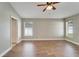 Primary bedroom with ceiling fan and two windows at 12739 Standbridge Dr, Riverview, FL 33579