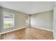 Bedroom with wood-look floors and two windows with blinds at 12739 Standbridge Dr, Riverview, FL 33579