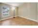 Spacious bedroom with wood-look floors and large window at 12739 Standbridge Dr, Riverview, FL 33579
