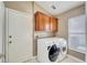 Convenient laundry room with washer, dryer, and cabinets at 12739 Standbridge Dr, Riverview, FL 33579