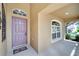 Purple front door with sidelights and a welcome mat at 12739 Standbridge Dr, Riverview, FL 33579