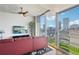 Modern living room with city view, red leather sofa, and balcony access at 777 N Ashley Dr # 1606, Tampa, FL 33602