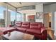 Living room with red sectional sofa and city views at 777 N Ashley Dr # 1606, Tampa, FL 33602
