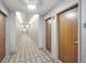 Bright hallway with wood doors and geometric patterned carpet at 777 N Ashley Dr # 1606, Tampa, FL 33602