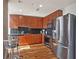 Modern kitchen with wood cabinets, black tile backsplash, and stainless steel appliances at 777 N Ashley Dr # 1606, Tampa, FL 33602