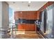 Modern kitchen with wood cabinets, black tile backsplash, and stainless steel appliances at 777 N Ashley Dr # 1606, Tampa, FL 33602