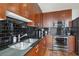 Modern kitchen with wood cabinets and stainless steel appliances at 777 N Ashley Dr # 1606, Tampa, FL 33602