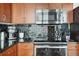 Modern kitchen with black tile backsplash and stainless steel appliances at 777 N Ashley Dr # 1606, Tampa, FL 33602
