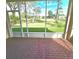 Screened patio with brick flooring and a view of the backyard and golf course at 34735 Double Eagle Ct, Zephyrhills, FL 33541