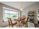 Bright dining area with built-in window seat and wood table at 739 Winterbrooke Way, Sun City Center, FL 33573