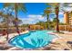 Inviting community pool with palm trees and a clear blue sky at 12033 Gandy N Blvd # 165, St Petersburg, FL 33702