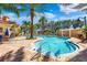 Community pool area with surrounding patio, lounge chairs, and lush landscaping at 12033 Gandy N Blvd # 165, St Petersburg, FL 33702