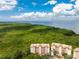 Aerial view of waterfront condo building with lush landscaping and water access at 12033 Gandy N Blvd # 165, St Petersburg, FL 33702