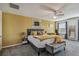 Bright and airy main bedroom with a king-size bed and yellow accent wall at 35744 Jenny Lynne Cir, Zephyrhills, FL 33541