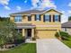 Two-story house with a two-car garage and landscaping at 35744 Jenny Lynne Cir, Zephyrhills, FL 33541