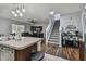 Open concept living area with hardwood floors and a modern staircase at 35744 Jenny Lynne Cir, Zephyrhills, FL 33541